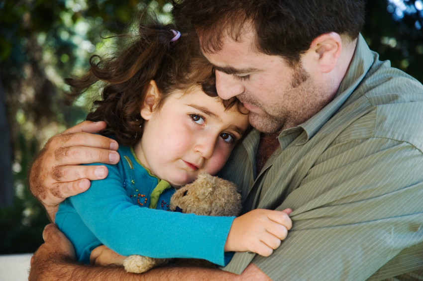 a man and his daughter hugging